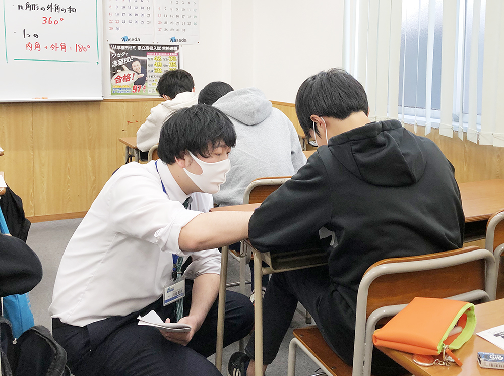 W早稲田ゼミの授業風景。わからない生徒に個別指導している教師。